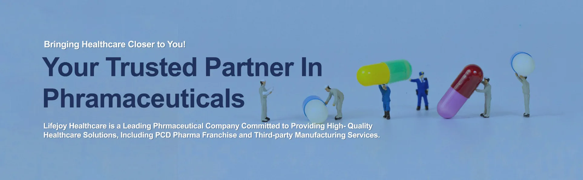 Top view of a laptop keyboard with hands typing, glasses, notebook, and pen on a desk